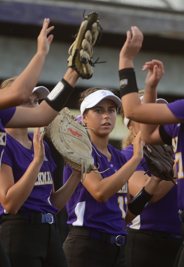 Hickman Kewpies varsity players high-five before the start of the softball game